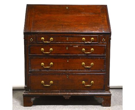 George III oak and mahogany bureau, fall front enclosing a well-fitted interior, with cupboard, pigeon-holes and drawers, bas