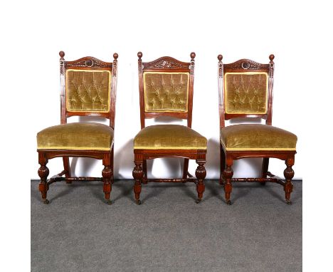 Set of six Victorian walnut dining chairs, carved frames with turned finials, turned and fluted legs on castors joined by rai