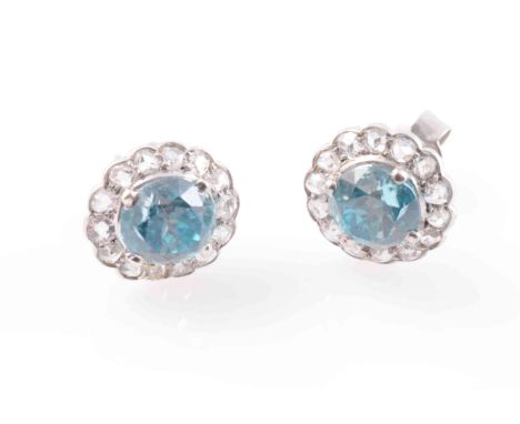 A PAIR OF BLUE ZIRCON AND DIAMOND EARRINGS, the round cut blue zircons each four claw set within a surround of fourteen old c