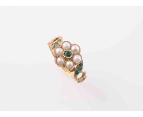 A GEORGIAN EMERALD AND SEED PEARL RING, the flower head shaped mount set to the centre with a single old cut emerald highligh