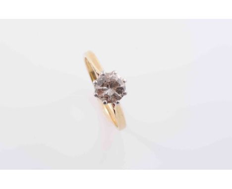A DIAMOND RING, the single brilliant cut diamond eight claw set in a simple pierced mount between pierced tapering shoulders 