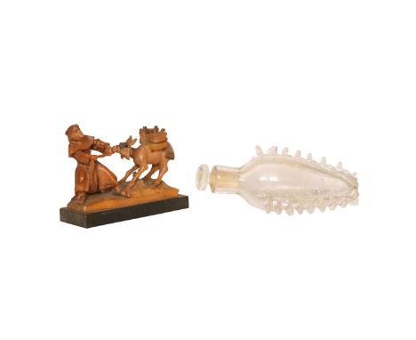 A CONTINENTAL NOVELTY BOXWOOD CARVING, LATE 19th CENTURY, of a monk pulling a recalcitrant donkey, on an ebonised plinth; tog