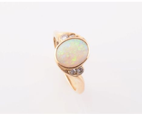 AN OPAL AND DIAMOND RING, the oval cut opal collet set to the centre of a twist design mount between two pairs of graduating 