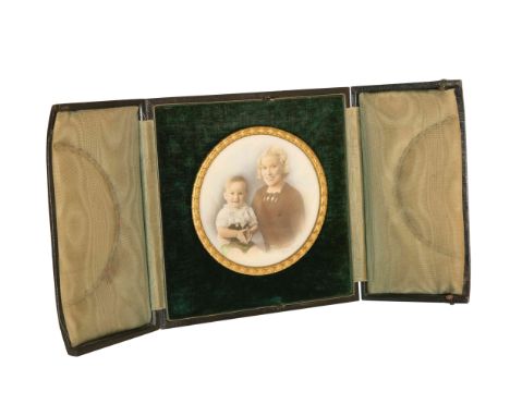 A 1930's HAND-COLOURED PHOTOGRAPHIC PORTRAIT OF A MOTHER AND CHILD, IN A GILT-METAL CIRCULAR FRAME, signed and contained in i