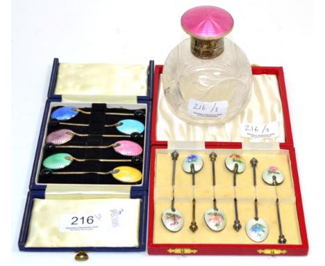 A cased set of six enamel coffee spoons with floral decoration, a further set of enamel coffee spoons and a silver and pink e