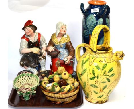 A Continental yellow-glazed earthenware jug with grotesque spout and incised portrait of a man, with foliate borders, 31cm hi