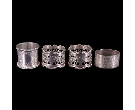 A pair of George V silver pierced napkin rings together with one other Victorian and an early 20th Century napkin ring, talle