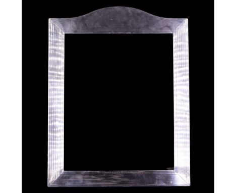 A large silver-faced photograph frame, of shouldered form and decorated overall with fine banded engine turning, circa 1930, 