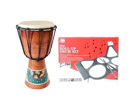 A bongo drum together with a USB roll-up drum kit, former 29 cm