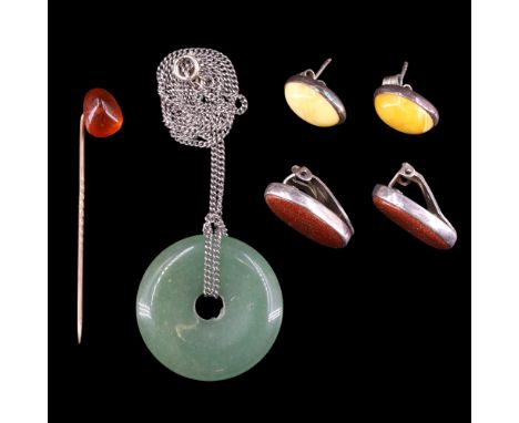 A group of polished hardstone jewellery comprising a pair of white metal mounted butterscotch stud earrings, an annular jade 