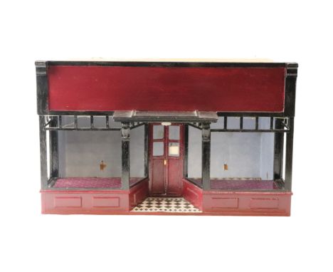 A large dolls shop or similar building, burgundy painted with black and white tile pattern floor, 12th scale, 51 cm x 33.5 cm