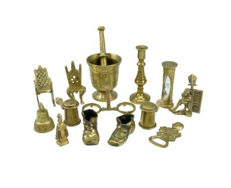 A quantity of domestic brassware including a pestle and mortar, a small novelty rocking chair, a salt and pepper condiment se