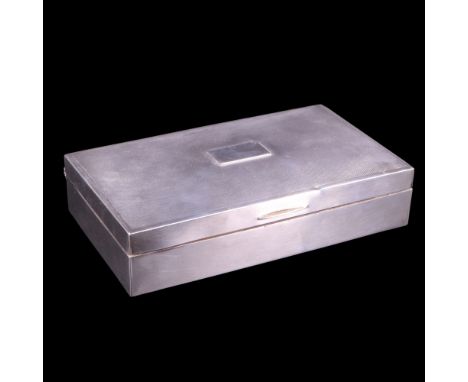 A 1940s silver cigarette box its subtly domed hinged lid decorated with fine engine turning centred by a vacant oblong cartou