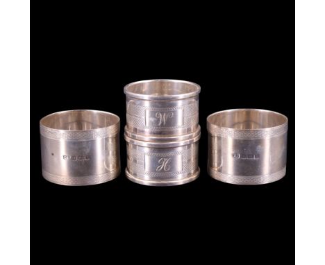 A pair of 1940s silver napkin rings together with a pair of 1920s silver rings each bearing latticed engine-turned decoration