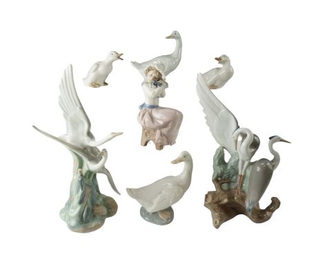 A group of Nao figurines comprising storks, geese and a young girl with puppy, tallest 26 cm