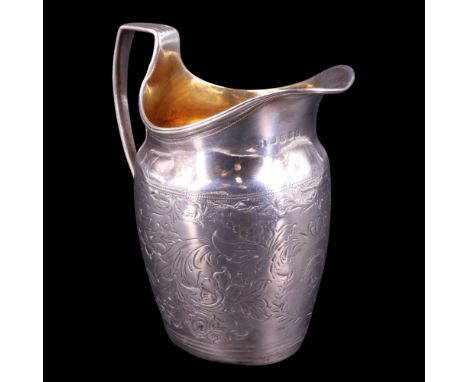 A George III silver cream jug, of helmet form with reeded rim and conforming square-shouldered handle, profusely foliate-scro