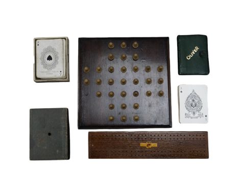 An early 20th Century square wooden solitaire board with turned wooden pieces, together with a St George series cribbage boar