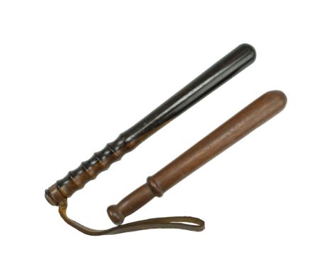 A turned lignum truncheon together with one other similar example, circa third quarter 20th Century, former length 39 cm