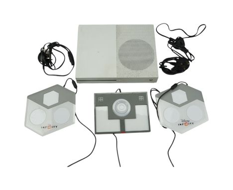 An Xbox One video game console together with two Disney Infinity and a Lego Dimensions base portals / pads 
