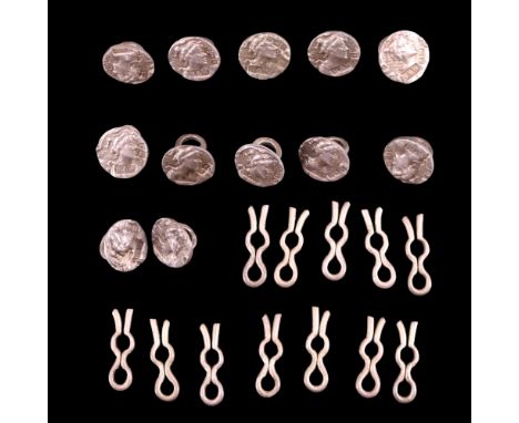 Twelve late 19th / early 20th Century diminutive silver buttons each decorated with a Romanesque profile, Reynolds &amp; West