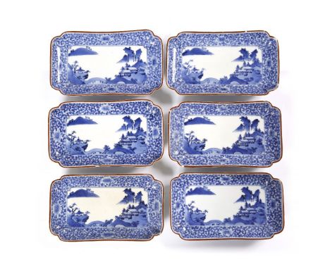 A Japanese set of six blue and white Arita rectangular dishes 18th Century decorated with a Chinese style landscape of three 