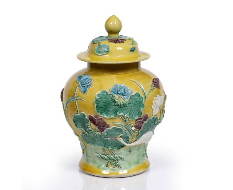 A Chinese porcelain inverted baluster vase and cover 19th Century decorated with white, blue and aubergine and green enamels 