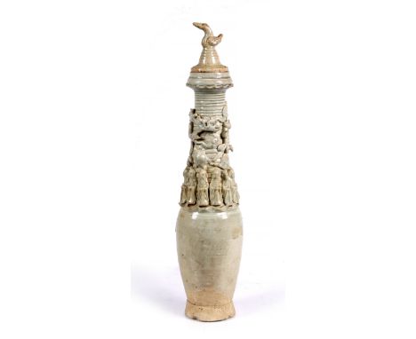 A Chinese celadon glaze funerary jar and cover Tang with various figures around the body and with bird finial, 57cm high
