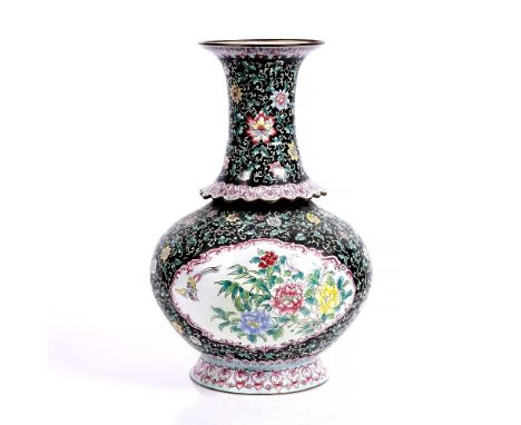 A Chinese enamel vase 19th/20th Century of black ground with panel of flowers and with raised rim around the neck, 37.5cm hig