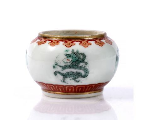 A Chinese porcelain brush washer of squat rounded form decorated with four green enamel dragon and phoenix roundels between c