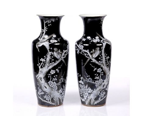 A large mirror pair of Chinese porcelain famille noire vases late 19th Century each decorated in white enamel with two birds 