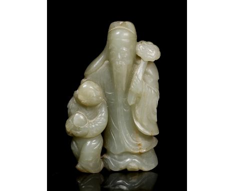 A Chinese green jade longevity figural group 18th/19th Century depicting a standing figure of Shou Lao holding a ruyi sceptre