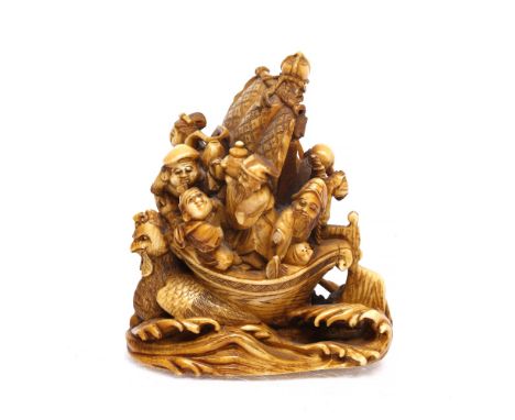 A Japanese ivory netsuke late Meiji period carved and undercut as the Seven Gods of Good Fortune (Shichifukujin) compactly gr