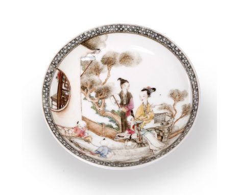 A Chinese porcelain saucer 18th Century decorated in famille rose enamels with two ladies seated and standing accompanied by 