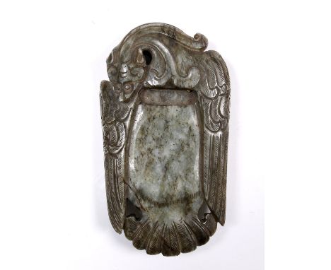 A Chinese black striated greyish green jade ink stone 18th/19th Century framed within the feathered wings and body of a  styl