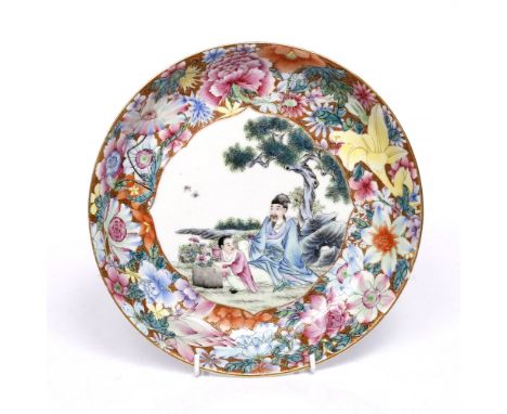 A Chinese enamel shallow dish Republic period the centre with scholar and child beneath a pine tree within a floral border, Q