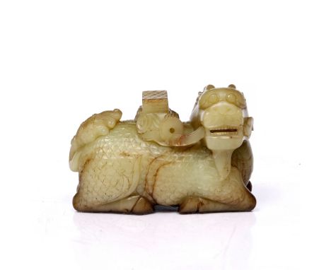 A Chinese jade model dragon 19th Century in the Ming style, the dragon with head turned to the right, 13cm across x 8cm high