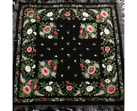 A Chinese lacework bordered black shawl 19th/20th Century finely embroidered allover in coloured silks with peony and other s