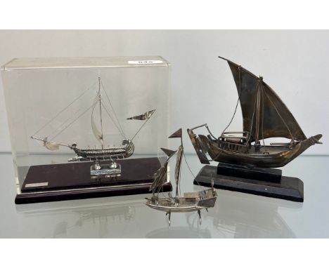 950 silver Greek ship model within a case together with two Chinese white metal junk boat models 