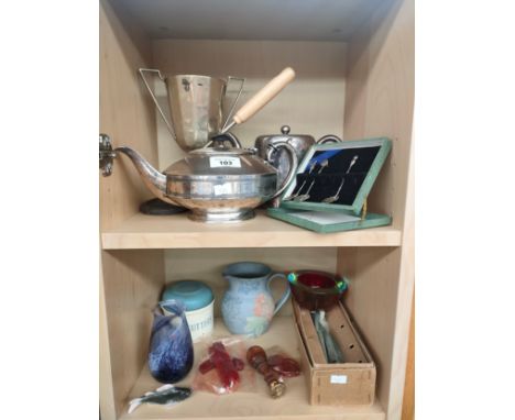 Two shelves of collectables to include silver plate, silver hallmarked continental spoons, Caithness glass and a Bain family 
