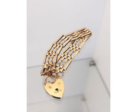 9ct yellow gold gate bracelet with heart shaped lock. [15.61grams] 