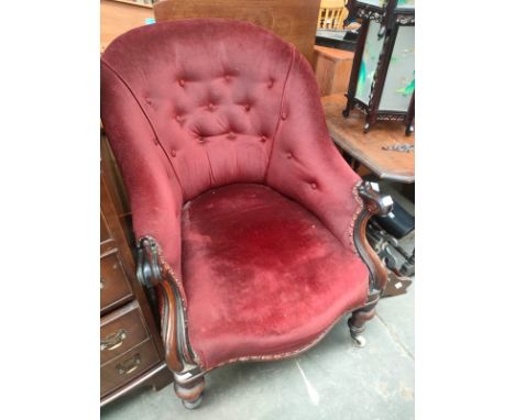 A 19th century button back arm chair 
