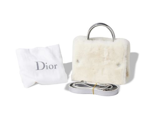 Embellished with white fur, silver hardware and silver leather strap.Metal plate 'Christian Dior, limited edition'24.5 x 22 c
