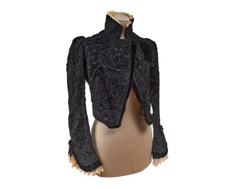 Vivid-black couture bolero jacket with lapel and sleeves, embellished in ivory-hued lace. The black skirt is made of wood, tr