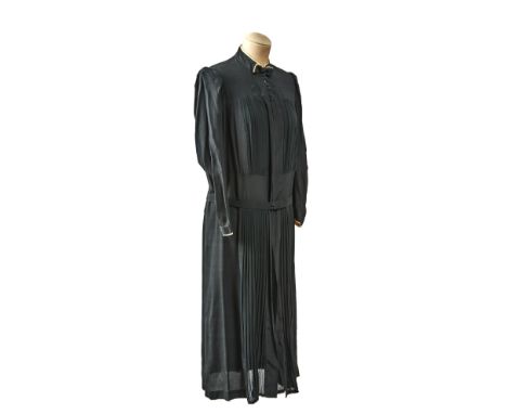 This art-deco era dress is made of soft silky material. Its pleated, it has an elegant bow decoration on the neck and long sl