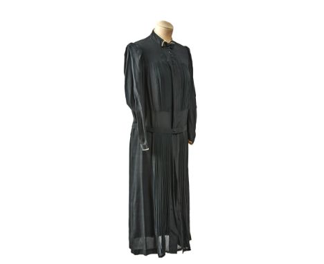 This art-deco era dress is made of soft silky material. Its pleated, it has an elegant bow decoration on the neck and long sl