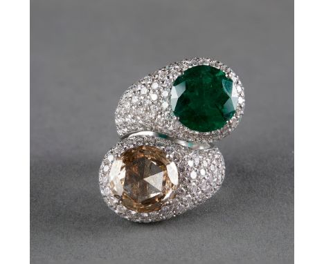 18k white gold bypass ring set with one cognac diamond and one emerald, with diamond surroundWeight: 29 grEmerald accompanied