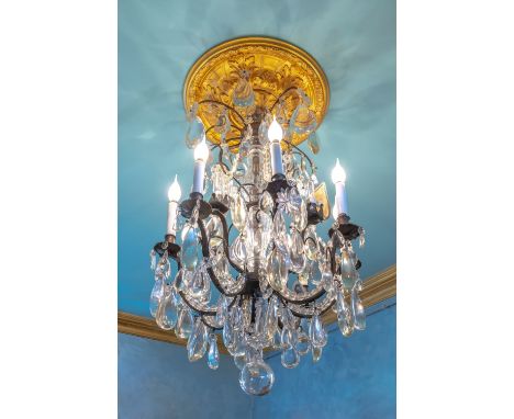 Chandelier forming an eight-light cage, decorated with pendants, plaques and rosettes.H. 90 cm