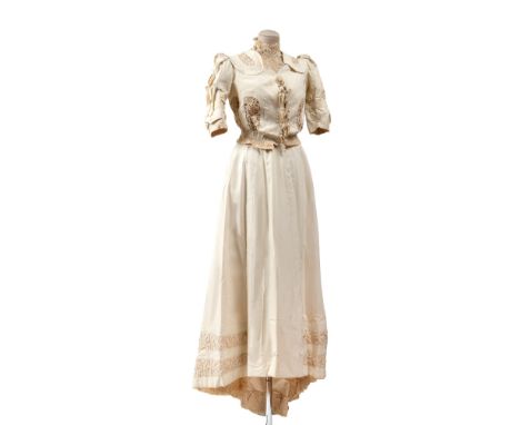 This ensemble consists of a jacket, a skirt, an additionalunderskirt, and a pillow. Inside, there is an ivory and gold woven 