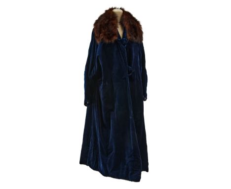 The coat has a straight cut. It has been made with soft, sapphire-hued velour fabric. One of the most surprising features of 