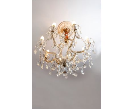 Eight-light chandelier decorated with pendants, plaques, rosettes and garlands.H. 80 cm